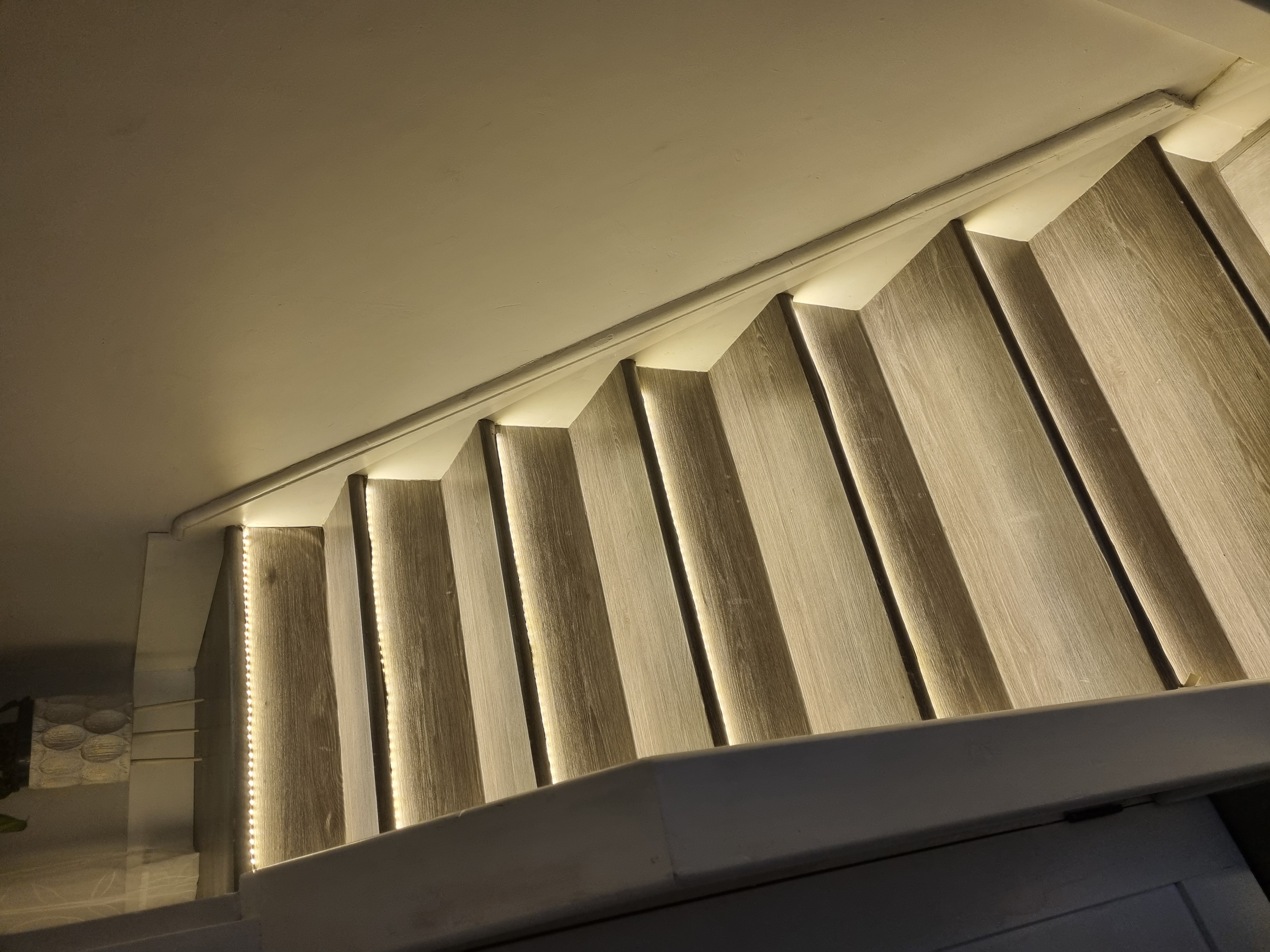 LED strip installation under each stair step with professional mounting